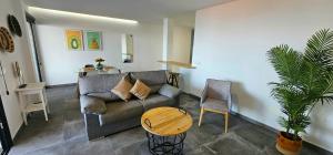 a living room with a couch and a table at Las Norias Apartamentos & Grill in Tazacorte +30 photos