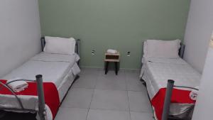 Un pat sau paturi într-o cameră la Pousada Das Camelias