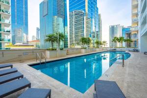 a swimming pool on the roof of a building with tall buildings at Luxe Brickell Gem with Huge Balcony n Ocean Views in Miami