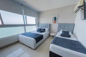 Postel nebo postele na pokoji v ubytování Edificio Palmetto Beach Apto 1702