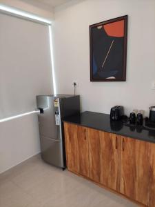 a kitchen with a refrigerator and a counter top at Elevar Ayanna in Bangalore