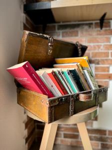 a suitcase filled with books on a stand at Civico36 in Ilbono