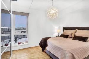a bedroom with a large bed and a large window at Beautiful home with seaview in Tromsø