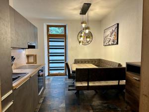 a kitchen and living room with a couch and a table at Stilvoll renovierte Wohnung in Lienz