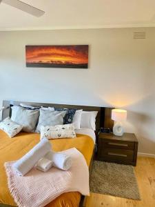 a bedroom with two beds and a painting on the wall at Saltwater Haven - Pets Welcome. Wifi. Amazing View in Apollo Bay