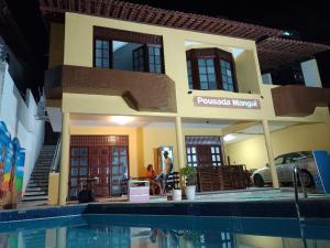 a model of a house next to a swimming pool at Pousada Mangai in João Pessoa