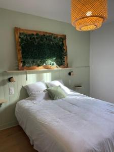 a white bed in a bedroom with a window at Nancy Thermal/Gare - Appartement élégant & cosy in Nancy
