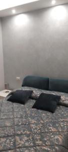 a bedroom with a bed with two pillows on it at Palazzo Brienza in Potenza
