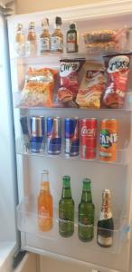 an open refrigerator filled with lots of drinks and snacks at R-RESIDENCe in Banja Luka