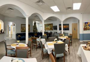 a restaurant with tables and chairs and a couch at Beautiful Beginnings at Bayside in Crystal River
