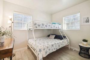 a bedroom with a bunk bed and a desk at Vanderbilt Mercado Villa Oasis. in Naples