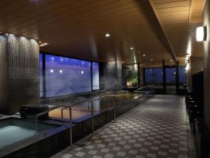 a large building with a hot tub in the middle at Hotel Monterey Kyoto in Kyoto