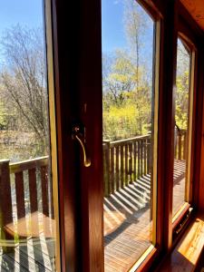 a glass door with a view of a deck at Secluded Rustic Cabin - A Digital Detox Paradise. in York