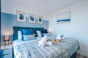 a bedroom with a large bed with blue walls at NEW! Stunning 2-bed apartment in Liverpool by 53 Degrees Property - Amazing location, Ideal for Small Groups - Sleeps 4! in Liverpool