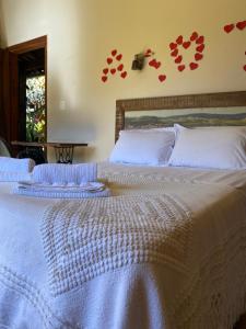 a bedroom with two beds with hearts on the wall at Escarpas do Caraça in Catas Altas