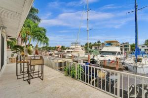 a balcony with boats docked at a marina at Beach Isles Modern 1BR Waterfront Apartment with Patio in Fort Lauderdale