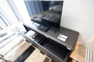 a flat screen tv on a table in a living room at 大久保駅から４分、貸切、韓国ダウン至近、新宿/歌舞伎町に徒歩圏内 、단독사용민박 in Tokyo