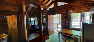 a log cabin with a desk and windows in it at BienAltura in Uspallata