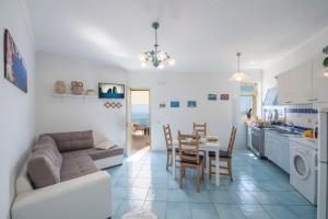 a living room and kitchen with a couch and a table at Casa Marianna in Praiano