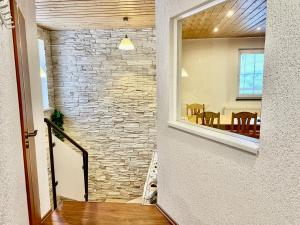 a hallway with a stone wall and a dining room at Popovská chalupa in Jáchymov