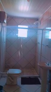 a bathroom with a toilet and a sink at Pousadas Mafra in Mafra +11 photos
