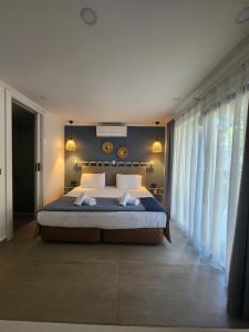 a bedroom with a large bed with white pillows at Park Hotel Rooms & Apart in Antalya