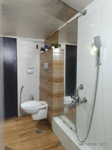 a bathroom with a shower and a toilet in it at Zoey's Hill View in Navi Mumbai