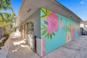 a wall with a flower mural on the side of a building at Pionciana Getaway 1BR Apartment Near FLL Airport in Fort Lauderdale