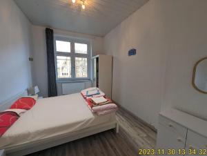 a small bedroom with a bed and a window at FeWo Hafen: Apartment in a Great Location in Dortmund