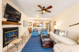 a living room with a couch and a fireplace at SunRiver E102 in Avon