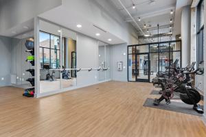 a gym with bikes and exercise equipment in a room at Mint House Greenville - West End in Greenville