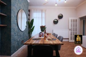 a dining room with a wooden table and a mirror at Clodien House, Great Location, Free Parking in Cardiff