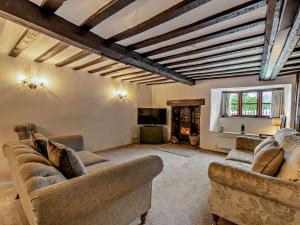 a living room with two couches and a fireplace at 3 Bed in Bishops Tawton 75872 in Umberleigh Bridge
