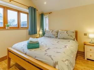 a bedroom with a large bed with blue curtains at 2 Bed in Usk 87285 in Llandenny
