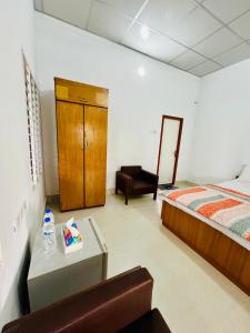 a bedroom with a bed and a table and a mirror at Fairy Hills ( Cottage & Park ) in Sreemangal