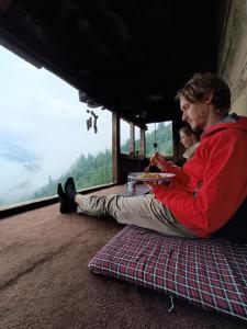 two men sitting on the floor of a bus looking out the window at Roohi in Nagar +16 photos