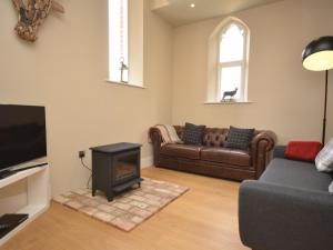 a living room with a couch and a fireplace at 2 bed in Alford 42581 