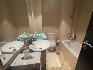 a bathroom with a sink and a toilet and a tub at Great view, Dubai SportCity, parking included, nice Apartments in Dubai