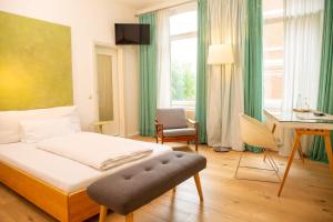 オルデンブルクにあるHotel Tafelfreudenのベッドルーム1室(ベッド1台、デスク、椅子付)