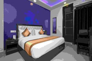 a bedroom with a bed in a purple room at Airport T Palace in New Delhi