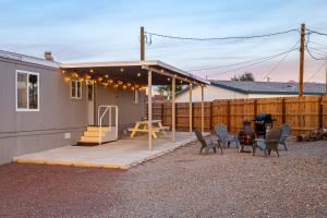 a house with a patio with chairs and a grill at Mountain Views minutes from casinos and Lake in Bullhead City