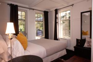 a bedroom with a bed and two windows at Bleu Azur 32 night Lakefront Retreat w Hot tub in Saint Adolphe D'Howard