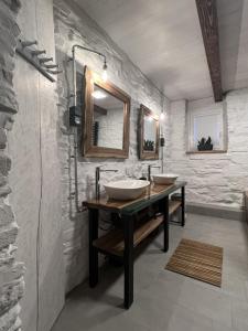 a bathroom with two sinks and two mirrors at Chata OXY in Ždiar