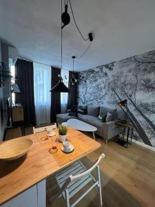 a living room with a table and a couch at Cozy Boutique Apartment in Plovdiv in Plovdiv