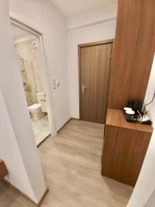 a room with a bathroom with a toilet and a door at Real City Suites Syntagma in Athens