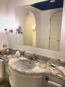 a bathroom with a sink and a mirror at Sheraton Sharm Hotel, Resort, Villas & Spa in Sharm El Sheikh