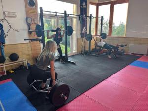 a group of women in a gym with weights at House Jaro in Velenje