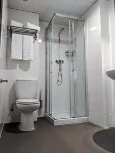 a bathroom with a toilet and a glass shower at Original Domino House in Valencia