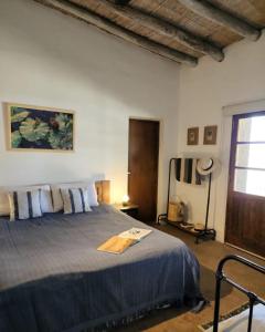 a bedroom with a large bed with blue sheets and a window at SANTA MARIA REINA in San Rafael