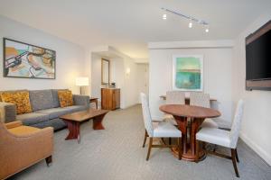 a living room with a couch and a table at Hilton Naples in Naples